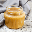 easy caramel sauce in a jar with a spoon