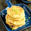 potato pancakes on blue plate sitting on wooden background